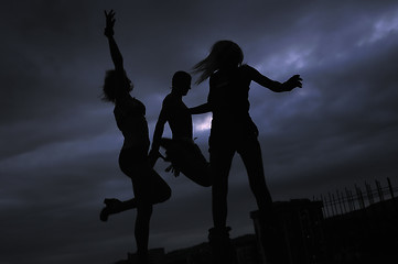 Image showing group of people jumping in air in night