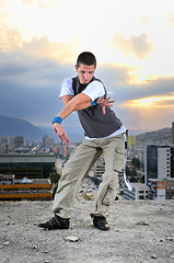 Image showing young man jumping in air outdoor at night ready to party