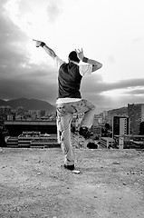 Image showing young man jumping in air outdoor at night ready to party