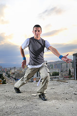 Image showing young man jumping in air outdoor at night ready to party