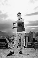 Image showing young man jumping in air outdoor at night ready to party