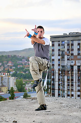 Image showing young man jumping in air outdoor at night ready to party