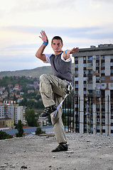 Image showing young man jumping in air outdoor at night ready to party