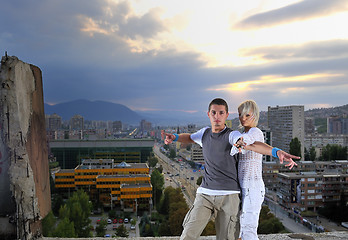 Image showing romantic urban couple dancing on top of  bulding