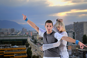 Image showing romantic urban couple dancing on top of  bulding