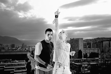 Image showing romantic urban couple dancing on top of  bulding