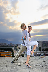 Image showing romantic urban couple dancing on top of  bulding