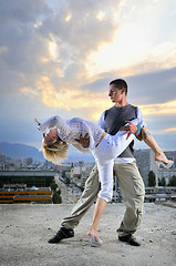 Image showing romantic urban couple dancing on top of  bulding