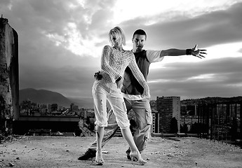 Image showing romantic urban couple dancing on top of  bulding