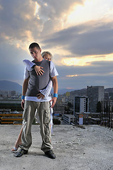 Image showing romantic urban couple dancing on top of  bulding