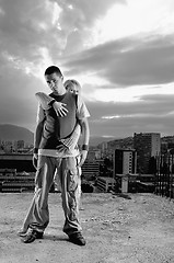 Image showing romantic urban couple dancing on top of  bulding