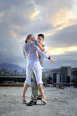 Image showing romantic urban couple dancing on top of  bulding