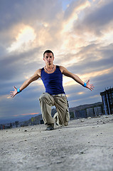 Image showing young man jumping in air outdoor at night ready to party