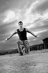 Image showing young man jumping in air outdoor at night ready to party