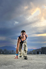 Image showing young man jumping in air outdoor at night ready to party