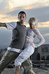 Image showing romantic urban couple dancing on top of the bulding 