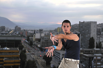 Image showing young man jumping in air outdoor at night ready for party