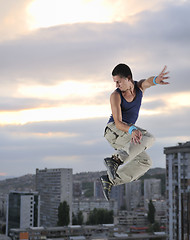 Image showing young man jumping in air outdoor at night ready for party