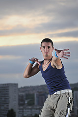 Image showing young man dancing and jumping  on top of the building 