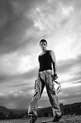 Image showing young man dancing and jumping  on top of the building 