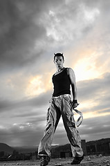 Image showing young man dancing and jumping  on top of the building 