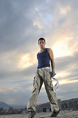 Image showing young man dancing and jumping  on top of the building 