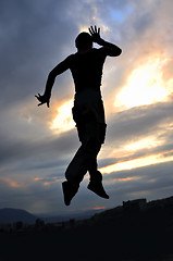 Image showing young man dancing and jumping  on top of the building 