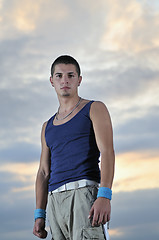 Image showing young man dancing and jumping  on top of the building 