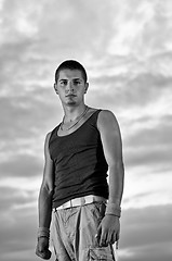 Image showing young man dancing and jumping  on top of the building 