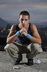 Image showing urban style boy portrait in crouch pose