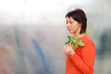 Image showing Beautiful  girl holding young plant