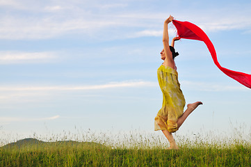 Image showing beautiful woman with red scarf on meadow