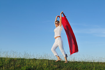 Image showing beautiful woman with red scarf on meadow