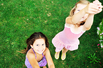 Image showing two happy girls have fun outdoor 