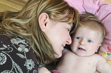 Image showing beautiful blonde young mother and cute baby