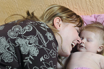 Image showing beautiful blonde young mother and cute baby