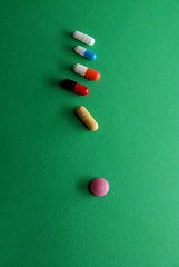 Image showing pills on green background