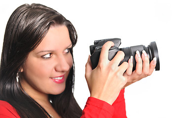 Image showing Young woman holding camera in hand taking picture isolated