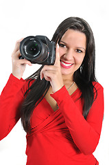 Image showing Young woman holding camera in hand taking picture isolated