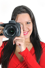 Image showing Young woman holding camera in hand taking picture isolated