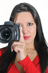 Image showing Young woman holding camera in hand taking picture isolated