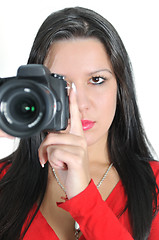 Image showing Young woman holding camera in hand taking picture isolated