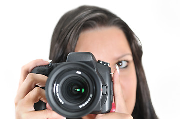 Image showing Young woman holding camera in hand taking picture isolated