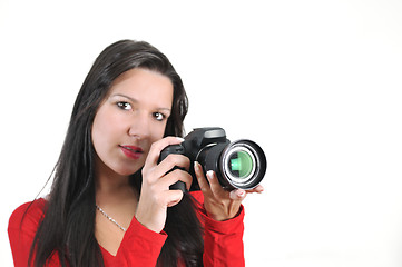 Image showing Young woman holding camera in hand taking picture isolated