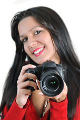 Image showing Young woman holding camera in hand taking picture isolated