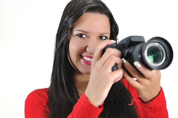 Image showing Young woman holding camera in hand taking picture isolated