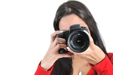 Image showing Young woman holding camera in hand taking picture isolated