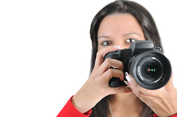 Image showing Young woman holding camera in hand taking picture isolated