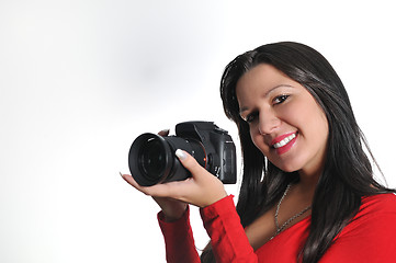 Image showing Young woman holding camera in hand taking picture isolated