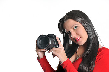 Image showing Young woman holding camera in hand taking picture isolated